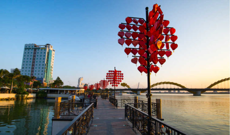 Couples visit the romantic Love Bridge to attach love locks as a symbol of their eternal bond