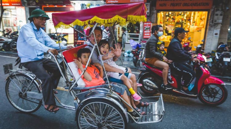 Visitors exploring Hanoi Old Quarters on cyclo.