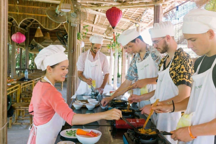 Visitors enjoy hands-on cooking experiences in Hoi An.