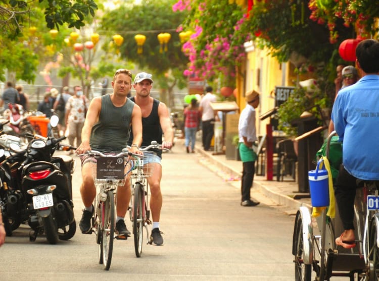 Tourists explore the charming town of Hoi An.